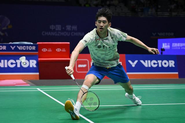Canada's Victor Lai hits a return to France's Toma Junior Popov during men's singles semi-final match at the China Open badminton open in Changzhou, eastern China's Jiangsu province on July 25, 2026. (Photo by CN-STR / AFP) / China OUT