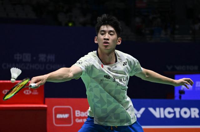 Canada's Victor Lai hits a return to France's Toma Junior Popov during men's singles semi-final match at the China Open badminton open in Changzhou, eastern China's Jiangsu province on July 25, 2026. (Photo by CN-STR / AFP) / China OUT