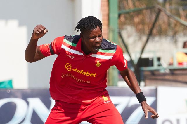 TOPSHOT - Zimbabwe's Blessing Muzarabani celebrates the wicket of Abishek Sharma during the second Twenty20 international cricket match between Zimbabwe and India at Harare Sports Club in Harare, on July 25, 2026. (Photo by Jekesai NJIKIZANA / AFP)