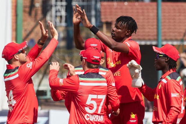 Zimbabwe's Blessing Muzarabani (2nd R) celebrates with teammates the wicket of Abishek Sharma during the second Twenty20 international cricket match between Zimbabwe and India at Harare Sports Club in Harare, on July 25, 2026. (Photo by Jekesai NJIKIZANA / AFP)