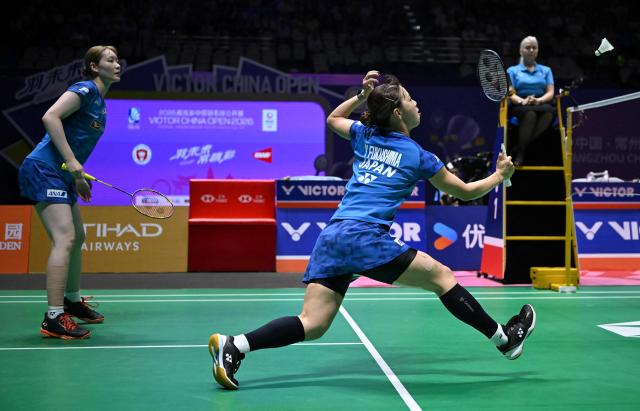 Japan's Yuki Fukushima (R) and Mayu Matsumoto (L) play against China's Li Yijing and Luo Xumin during their women's doubles semifinal match at the China Open badminton tournament in Changzhou, eastern China Jiangsu province on July 25, 2026. (Photo by CN-STR / AFP) / China OUT