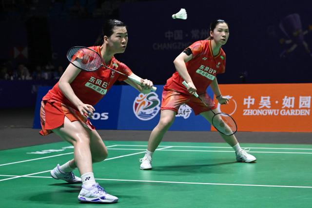 China's Luo Xumin (L) and Li Yijing (R) play against Japan's Yuki Fukushima and Mayu Matsumoto during their women's doubles semifinal match at the China Open badminton tournament in Changzhou, eastern China Jiangsu province on July 25, 2026. (Photo by CN-STR / AFP) / China OUT