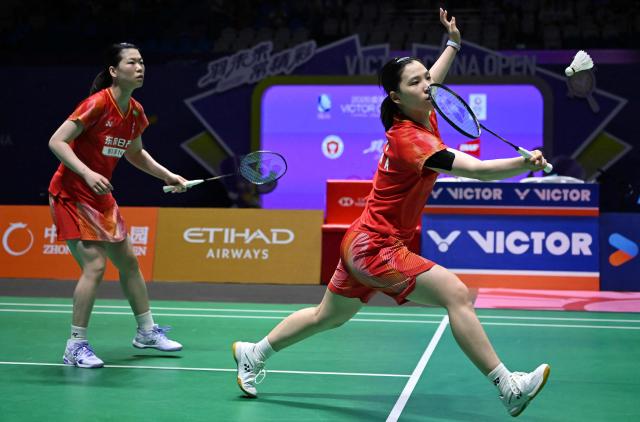 China's Li Yijing (R) and Luo Xumin (L) play against Japan's Yuki Fukushima and Mayu Matsumoto during their women's doubles semifinal match at the China Open badminton tournament in Changzhou, eastern China Jiangsu province on July 25, 2026. (Photo by CN-STR / AFP) / China OUT