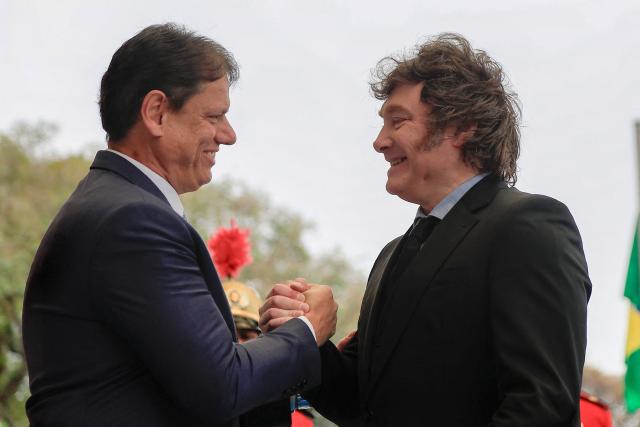 Argentina's president Javier Milei shakes hands with Sao Paulo's governor Tarcisio de Freitas on arrival at the Bandeirantes Palace, in Sao Paulo, Brazil on July 25, 2026. Milei is visiting Brazil to meet with right-wing presidential hopeful Flavio Bolsonaro and take part in the Liberal Party convention that supports his candidacy, (Photo by Miguel SCHINCARIOL / AFP)
