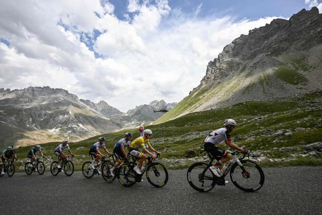 UAE Team Emirates - XRG's Austrian rider Felix Grossschartner (R) leads UAE Team Emirates - XRG's Slovenian rider Tadej Pogacar wearing the overall leader's yellow jersey and Red Bull - BORA - hansgrohe team's Belgian rider Remco Evenepoel (3rd R) in the Col du Galibier ascent during the 20th stage of the 113th edition of the Tour de France cycling race, 170,9 km between Le Bourg-d'Oisans and Alpe d'Huez in the French Alps, on July 25, 2026. (Photo by Loic VENANCE / AFP)