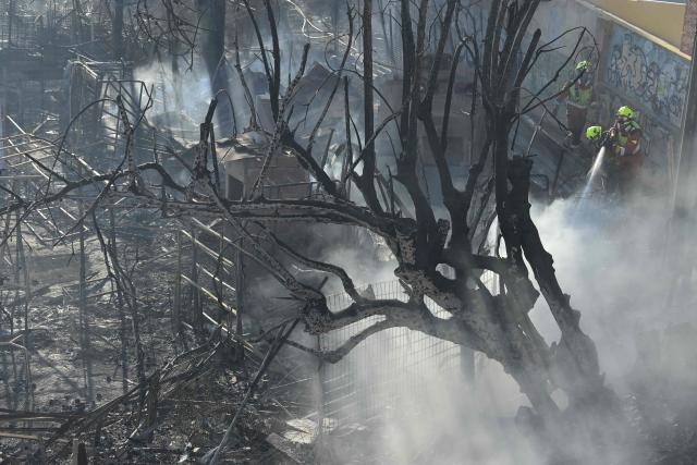 Firefighters battle a fire that killed one person, in a area of vegetables garden and orchards in a gorge of Manises, eastern Spain, on July 25, 2026. A fire in a ravine near Valencia, in the east of Spain, killed one person, according to the local authority in the affected town of Manises. (Photo by Jose JORDAN / AFP)