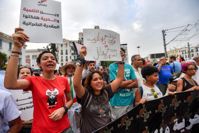 People gather to protest Tunisia's President Kais Saied during a demonstration marking five years since his suspension of parliament and assumption of emergency powers, in Tunis on July 25, 2026. (Photo by FETHI BELAID / AFP)