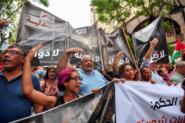 People gather to protest Tunisia's President Kais Saied during a demonstration marking five years since his suspension of parliament and assumption of emergency powers, in Tunis on July 25, 2026. (Photo by FETHI BELAID / AFP)