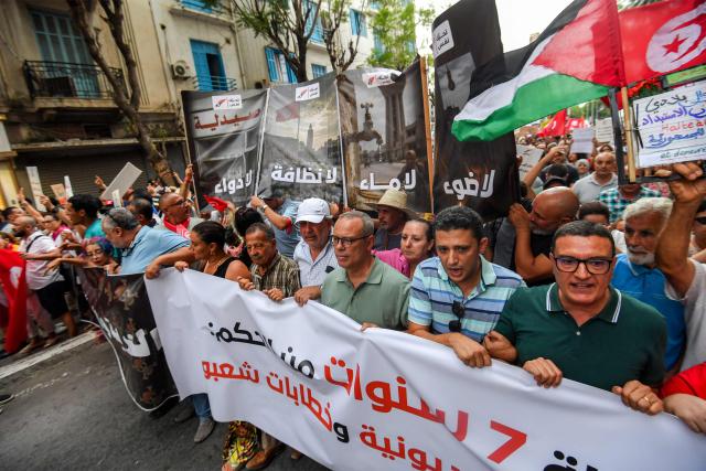 People gather to protest Tunisia's President Kais Saied during a demonstration marking five years since his suspension of parliament and assumption of emergency powers, in Tunis on July 25, 2026. (Photo by FETHI BELAID / AFP)