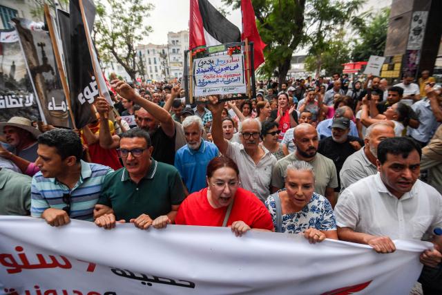 People gather to protest Tunisia's President Kais Saied during a demonstration marking five years since his suspension of parliament and assumption of emergency powers, in Tunis on July 25, 2026. (Photo by FETHI BELAID / AFP)