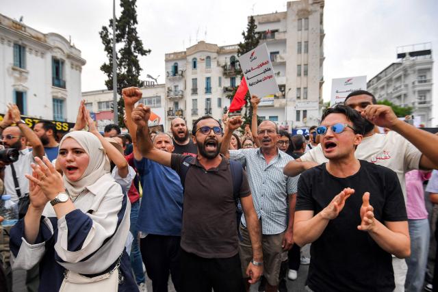 People gather to protest Tunisia's President Kais Saied during a demonstration marking five years since his suspension of parliament and assumption of emergency powers, in Tunis on July 25, 2026. (Photo by FETHI BELAID / AFP)