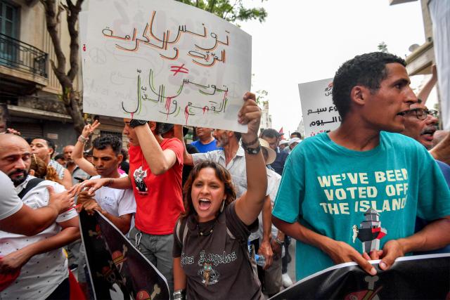 People gather to protest Tunisia's President Kais Saied during a demonstration marking five years since his suspension of parliament and assumption of emergency powers, in Tunis on July 25, 2026. (Photo by FETHI BELAID / AFP)