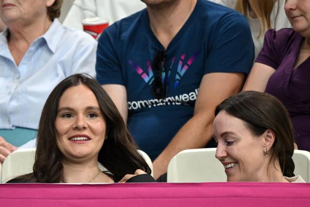 Holly Ramsey (L), wife of England's Adam Ramsay-Peaty, watches from the stands during the swimming event at the Tollcross International Swimming Centre in Glasgow, on day two of the Commonwealth Games in Glasgow, Scotland, on July 25, 2026. (Photo by Oli SCARFF / AFP)