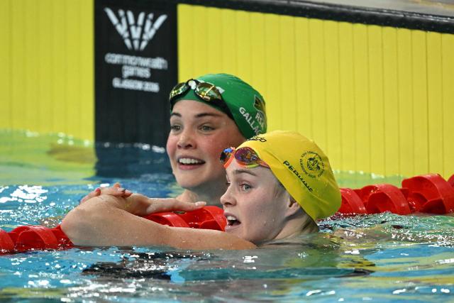 Australia's Alex Perkins (R) and South Africa's Erin Gallagher react after the Women's 50m Butterfly Final during the swimming event at the Tollcross International Swimming Centre in Glasgow, on day two of the Commonwealth Games in Glasgow, Scotland, on July 25, 2026. (Photo by Oli SCARFF / AFP)