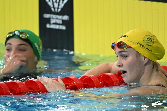 Australia's Alex Perkins (R) and South Africa's Erin Gallagher react after the Women's 50m Butterfly Final during the swimming event at the Tollcross International Swimming Centre in Glasgow, on day two of the Commonwealth Games in Glasgow, Scotland, on July 25, 2026. (Photo by Oli SCARFF / AFP)