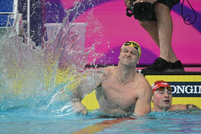 Australia's Sam Williamson reacts after winning the Men's 100m Breaststroke Final during the swimming event at the Tollcross International Swimming Centre in Glasgow, on day two of the Commonwealth Games in Glasgow, Scotland, on July 25, 2026. England's Adam Ramsay-Peaty (R) finsihed third. (Photo by Oli SCARFF / AFP)
