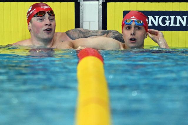 England's Adam Ramsay-Peaty (L) and Jersey's Filip Nowacki react after the Men's 100m Breaststroke Final at the swimming event at the Tollcross International Swimming Centre in Glasgow, on day two of the Commonwealth Games in Glasgow, Scotland, on July 25, 2026. (Photo by Oli SCARFF / AFP)