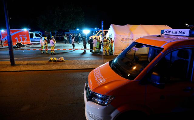 Emergency personnel and police work near the scene where one person was killed and around 15 injured after a car is believed to have hit the crowd on the outskirts of the Christopher Street Day (CSD) parade in Berlin, on July 25, 2026. "We believe that a vehicle entered the Tiergarten park and hit several people and injured them," police posted on social media. The injured were being treated by the emergency services and they were actively seeking the people responsible, they added. (Photo by RALF HIRSCHBERGER / AFP)
