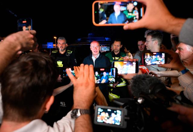 Berlin's mayor Kai Wegner speaks to the media near the scene where one person was killed and around 15 injured after a car is believed to have hit the crowd on the outskirts of the Christopher Street Day (CSD) parade in Berlin, on July 25, 2026. "We believe that a vehicle entered the Tiergarten park and hit several people and injured them," police posted on social media. The injured were being treated by the emergency services and they were actively seeking the people responsible, they added. (Photo by RALF HIRSCHBERGER / AFP)