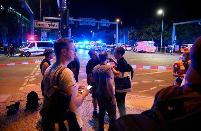 Emergency personnel and police work near the scene where one person was killed and around 15 injured after a car is believed to have hit the crowd on the outskirts of the Christopher Street Day (CSD) parade in Berlin, on July 25, 2026. "We believe that a vehicle entered the Tiergarten park and hit several people and injured them," police posted on social media. The injured were being treated by the emergency services and they were actively seeking the people responsible, they added. (Photo by RALF HIRSCHBERGER / AFP)