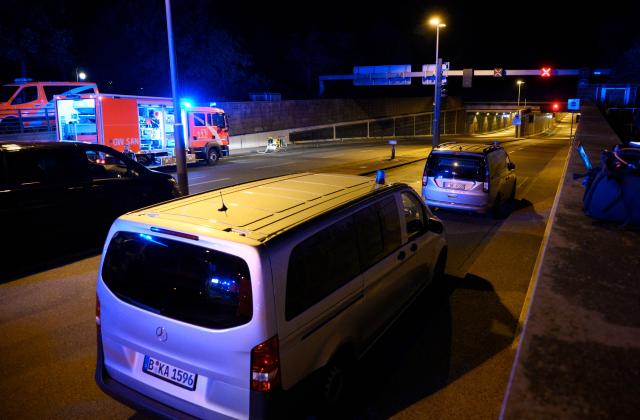 Police cars and ambulances stand at the entrance of the Tiergarten tunnel near the scene where one person was killed and around 15 injured after a car is believed to have hit the crowd on the outskirts of the Christopher Street Day (CSD) parade in Berlin, on July 25, 2026. "We believe that a vehicle entered the Tiergarten park and hit several people and injured them," police posted on social media. The injured were being treated by the emergency services and they were actively seeking the people responsible, they added. (Photo by RALF HIRSCHBERGER / AFP)