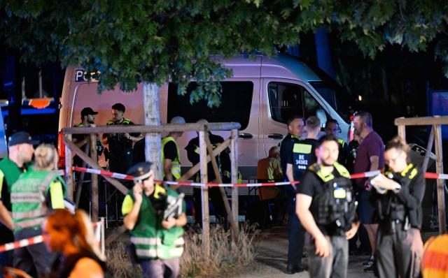 Police work near the scene where one person was killed and around 15 injured after a car is believed to have hit the crowd on the outskirts of the Christopher Street Day (CSD) parade in Berlin, on July 25, 2026. "We believe that a vehicle entered the Tiergarten park and hit several people and injured them," police posted on social media. The injured were being treated by the emergency services and they were actively seeking the people responsible, they added. (Photo by RALF HIRSCHBERGER / AFP)