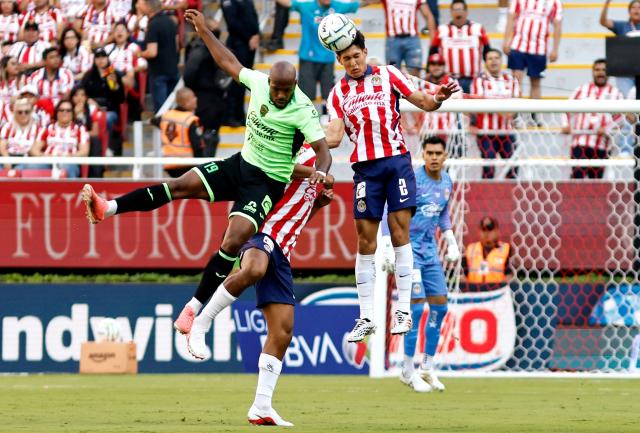 Guadalajara's defender #02 Jose Castillo and Juarez's Colombian forward #19 Oscar Estupinan fight for the ball during the Liga MX Apertura football match between Guadalajara and Juarez at the Akron stadium in Zapopan, Jalisco, Mexico on July 25, 2026. (Photo by ULISES RUIZ / AFP)