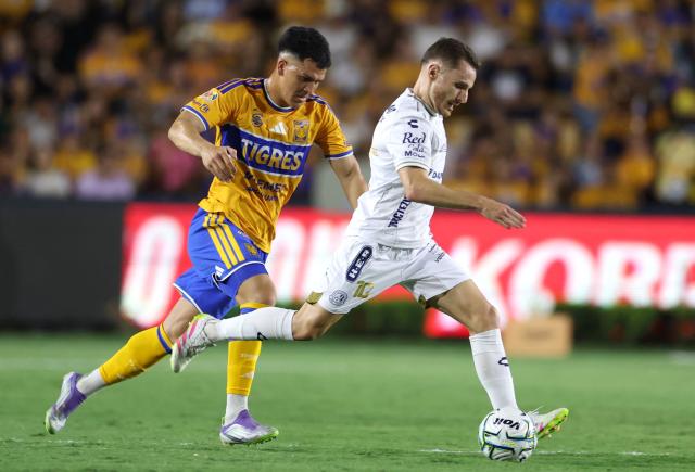 Tigres' Uruguayan midfielder #05 Cesar Araujo and San Luis' French midfielder #10 Sebastien Salles-Lamonge fight for the ball during the Liga MX Apertura football match between Tigres and San Luis at the Universitario stadium in San Nicolas de los Garza, state of Nuevo Leon, Mexico on July 25, 2026. (Photo by Julio Cesar AGUILAR / AFP)