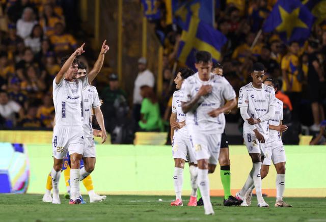 San Luis' Spanish forward #22 Rafa Llorente celebrates with teammates after scoring the equalising goal during the Liga MX Apertura football match between Tigres and San Luis at the Universitario stadium in San Nicolas de los Garza, state of Nuevo Leon, Mexico on July 25, 2026. (Photo by Julio Cesar AGUILAR / AFP)
