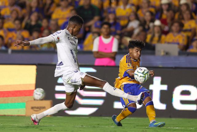 San Luis' defender #03 Eduardo Aguila and Tigres' forward #30 Diego Sanchez fight for the ball during the Liga MX Apertura football match between Tigres and San Luis at the Universitario stadium in San Nicolas de los Garza, state of Nuevo Leon, Mexico on July 25, 2026. (Photo by Julio Cesar AGUILAR / AFP)