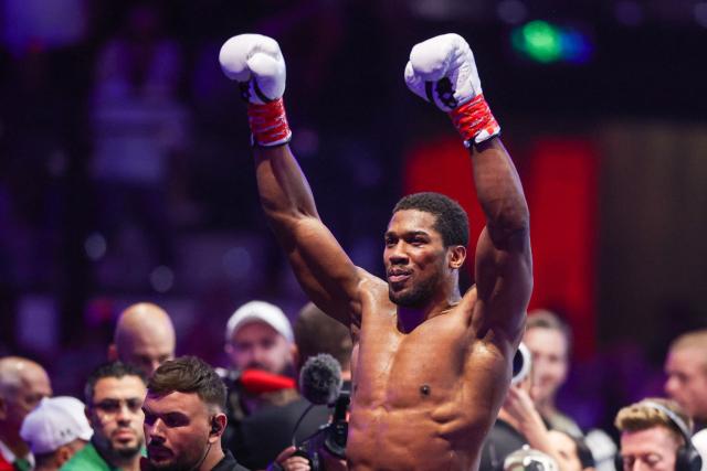 Britain's boxer Anthony Joshua celebrates winning against Albania's boxer Kristian Prenga in their heavyweight boxing fight at the Jeddah Superdome in Jeddah on July 26, 2026. Two-time heavyweight world champion Anthony Joshua survived two early knockdowns on the way to a second-round knockout of Kristian Prenga on July 26, his triumphant ring return paving the way for a blockbuster all-British bout with Tyson Fury. (Photo by AFP)