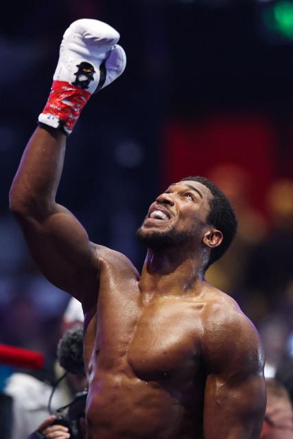 Britain's boxer Anthony Joshua celebrates winning against Albania's boxer Kristian Prenga in their heavyweight boxing fight at the Jeddah Superdome in Jeddah on July 26, 2026. Two-time heavyweight world champion Anthony Joshua survived two early knockdowns on the way to a second-round knockout of Kristian Prenga on July 26, his triumphant ring return paving the way for a blockbuster all-British bout with Tyson Fury. (Photo by AFP)