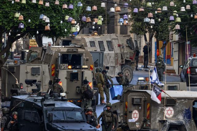 Israeli army soldiers conduct a raid in Nablus, in the Israeli-occupied West Bank on July 26, 2026. The Israeli military said a violent confrontation broke out between Israelis and Palestinians in the occupied West Bank on July 25, a day after clashes elsewhere in the territory left six people dead. Violence in the Israeli-occupied West Bank has surged since the Gaza war began with Hamas's October 7, 2023 attack on Israel. (Photo by Zain JAAFAR / AFP)