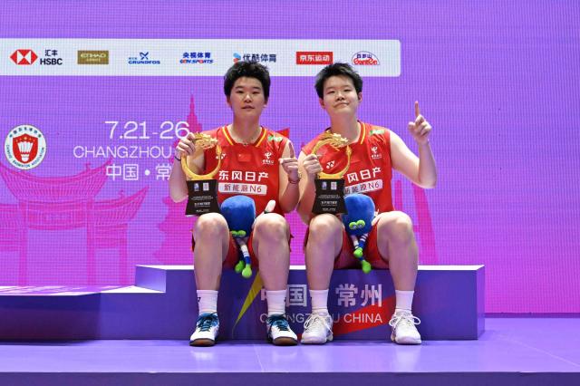 China's Liu Shengshu (R) and Tan Ning pose on the podium after defeating Japan's Yuki Fukushima and Mayu Matsumoto during their women's doubles final match at the China Open badminton tournament in Changzhou, eastern China Jiangsu province on July 26, 2026. (Photo by CN-STR / AFP) / China OUT