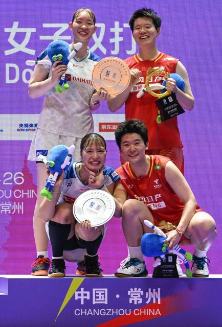 Winners China's Liu Shengshu (top R) and Tan Ning (botton R) and runners up Japan's Yuki Fukushima (botton L) and Mayu Matsumoto (top L) pose on the podium during the awarding ceremony after their women's doubles final match at the China Open badminton tournament in Changzhou, eastern China Jiangsu province on July 26, 2026. (Photo by CN-STR / AFP) / China OUT