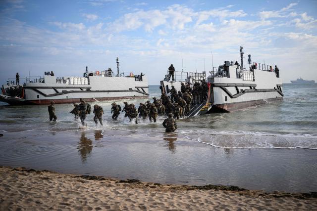 (FILES) French troops disembark from a US landing craft during a joint US and French amphibious landing operation showcase, on June 4, 2024, at Omaha beach in Saint-Laurent-sur-Mer, northwestern France, ahead of the "D-Day" commemorations marking the 80th anniversary of the World War II Allied landings in Normandy. Several D-Day landing beaches have been added to UNESCO’s World Heritage List on July 26, 2026, the culmination of a project launched nearly 20 years ago that could boost tourism. (Photo by LOIC VENANCE / AFP)