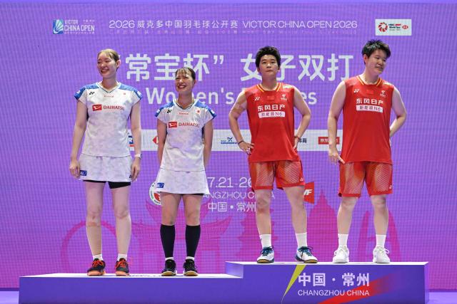 Winners China's Liu Shengshu (R) and Tan Ning (2nd-R) and runners up Japan's Yuki Fukushima (2nd-L) and Mayu Matsumoto (L) pose on the podium during the awarding ceremony after their women's doubles final match at the China Open badminton tournament in Changzhou, eastern China Jiangsu province on July 26, 2026. (Photo by CN-STR / AFP) / China OUT