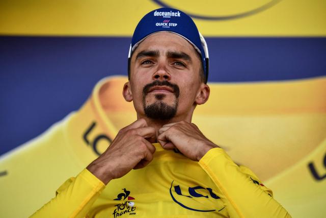 (FILES) France's Julian Alaphilippe wearing his overall leader's yellow jersey reacts on the podium after the fourth stage of the 106th edition of the Tour de France cycling race between Reims and Nancy, in Nancy, eastern France, on July 9, 2019. “You shouldn’t expect to see me again”: French rider Julian Alaphilippe, double world champion and multiple-time wearer of the yellow jersey in the Tour de France, said on July 25, 2026, that he is unlikely to return to the race after the penultimate stage of this 113th edition. (Photo by JEFF PACHOUD / AFP)