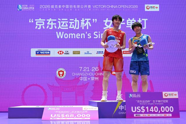 Winner Japan's Akane Yamaguchi (R) and runner up China's Chen Yufei pose on the podium during the awarding ceremony after their women's singles final match at the China Open badminton tournament in Changzhou, eastern China's Jiangsu province on July 26, 2026. (Photo by CN-STR / AFP) / China OUT