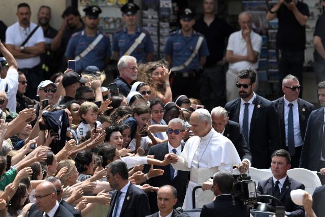 Pope Leo XIV greets the crowd after the Angelus prayer from the entrance of the Apostolic Palace in Piazza della Liberta (Liberty Square) at the summer papal residence in Castel Gandolfo on July 26, 2026. (Photo by TIZIANA FABI / AFP)