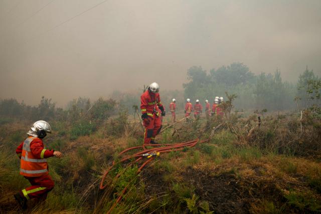 Brigade des Sapeurs-Pompiers de Paris (BSPP) firefighters work to extinguish a fire in Marcheprime, west of Bordeaux on July 26, 2026 as a wildfire has been ravaging the forest north of the Arcachon Basin (Gironde) since July 22. The fire that has engulfed the area around the Arcachon Basin and is now threatening the outskirts of the Bordeaux metropolitan area has destroyed 42,000 hectares of “burned area,” the Gironde prefecture announced; the prefecture has evacuated a total of 220,000 people since July 22. (Photo by ALAIN JOCARD / AFP)