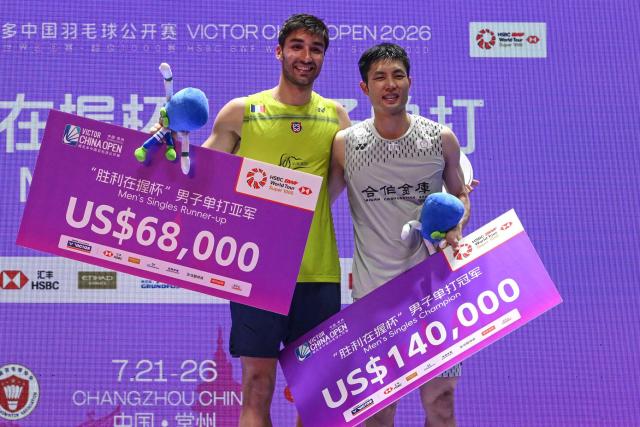 Winnner Taiwan's Chou Tien-chen (R) and runner up France's Toma Junior Popov pose on the podium after their men's singles final match at China Open badminton tournament in Changzhou, eastern China's Jiangsu province on July 26, 2026. (Photo by CN-STR / AFP) / China OUT