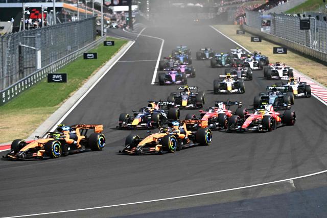 McLaren's British driver Lando Norris (L) followed by McLaren's Australian driver Oscar Piastri (3-L) and other cars compete during the Formula One Hungarian Grand Prix at the Hungaroring racetrack in Mogyorod near Budapest, Hungary, on July 26, 2026. (Photo by Attila KISBENEDEK / AFP)
