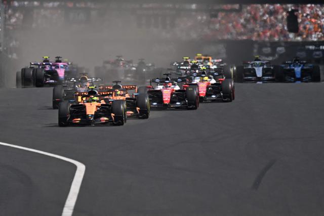 McLaren's British driver Lando Norris (C) followed by McLaren's Australian driver Oscar Piastri (C-R) and other cars compete during the Formula One Hungarian Grand Prix at the Hungaroring racetrack in Mogyorod near Budapest, Hungary, on July 26, 2026. (Photo by Attila KISBENEDEK / AFP)