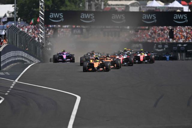 McLaren's British driver Lando Norris (C) followed by McLaren's Australian driver Oscar Piastri and other cars compete during the Formula One Hungarian Grand Prix at the Hungaroring racetrack in Mogyorod near Budapest, Hungary, on July 26, 2026. (Photo by Attila KISBENEDEK / AFP)
