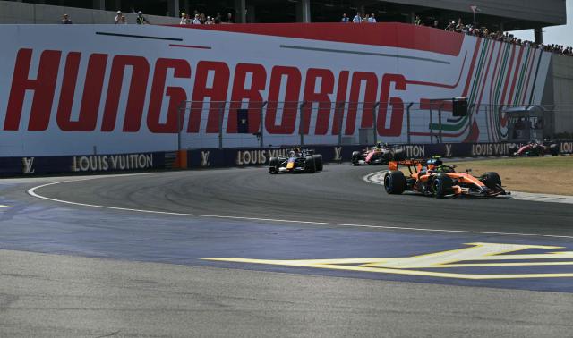 McLaren's British driver Lando Norris competes ahead of Red Bull Racing's Dutch driver Max Verstappen, Ferrari's British driver Lewis Hamilton, and Ferrari's Monegasque driver Charles Leclerc during the Formula One Hungarian Grand Prix at the Hungaroring racetrack in Mogyorod near Budapest, Hungary, on July 26, 2026. (Photo by Andrej ISAKOVIC / AFP)