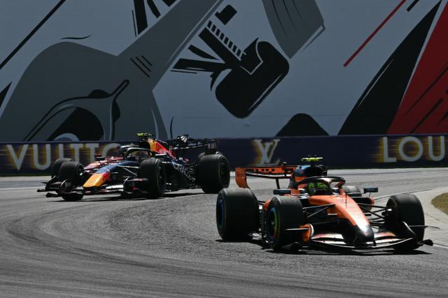 McLaren's British driver Lando Norris competes ahead of Red Bull Racing's Dutch driver Max Verstappen during the Formula One Hungarian Grand Prix at the Hungaroring racetrack in Mogyorod near Budapest, Hungary, on July 26, 2026. (Photo by Andrej ISAKOVIC / AFP)