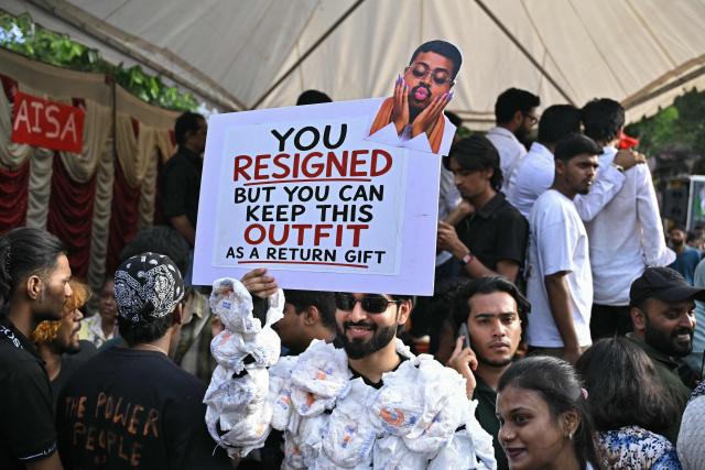 A man holds a placard during a victory gathering organised by the All India Students' Association (AISA) in Bengaluru on July 26, 2026 a day after the Cockroach Janta Party (CJP) ended their protest in New Delhi's Jantar Mantar following the resignation of India's Education Minister Dharmendra Pradhan over alleged NEET examination irregularities. (Photo by Idrees MOHAMMED / AFP)