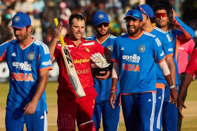 Zimbabwe's Ryan Burl (2nd L) speaks with Indian players after India’s victory during the third Twenty20 international cricket match between Zimbabwe and India at Harare Sports Club in Harare, on July 26, 2026. (Photo by Jekesai NJIKIZANA / AFP)