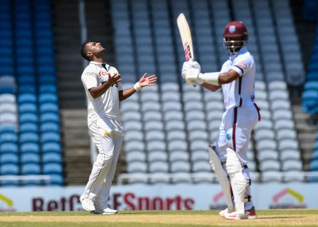 Mohammad Ali (L) of Pakistan express disappointment as Shai Hope (R) of West Indies is not caught during the 2nd day of 1st Test match between West Indies and Pakistan at Brian Lara Cricket Academy in Tarouba, Trinidad and Tobago on July 26, 2026. (Photo by Randy Brooks / AFP)